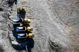 Dump trucks sit at an aggregate mine processing facility. (James MacDonald/Bloomberg via Getty Images)