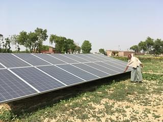 Dingur Patel shows us the solar panel lighting up the village