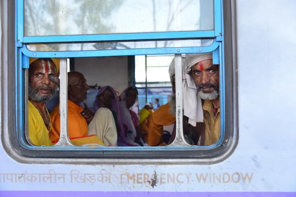 Sadhus on board a Simhastha special train leaving Bhopal to Ujjain to attend Simhastha Mahakumbh at Bhopal railway station  in Bhopal, India. (Mujeeb Faruqui/Hindustan Times via GettyImages) 