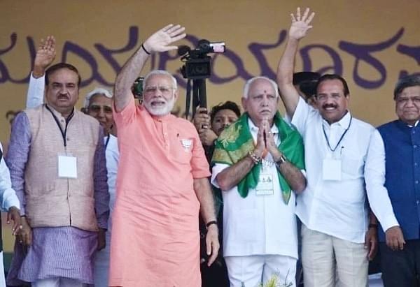 Prime Minister Narendra Modi with BJP’s chief ministerial candidate for upcoming Karnataka Assembly election, B S Yeddyurappa, at a rally. (Arijit Sen/Hindustan Times via GettyImages)