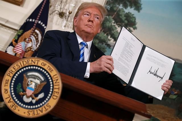 US President Donald Trump holds up a memorandum that reinstates sanctions on Iran after he announced his decision to withdraw the US from the 2015 Iran nuclear deal in&nbsp; Washington. (Chip Somodevilla/Getty Images)&nbsp;