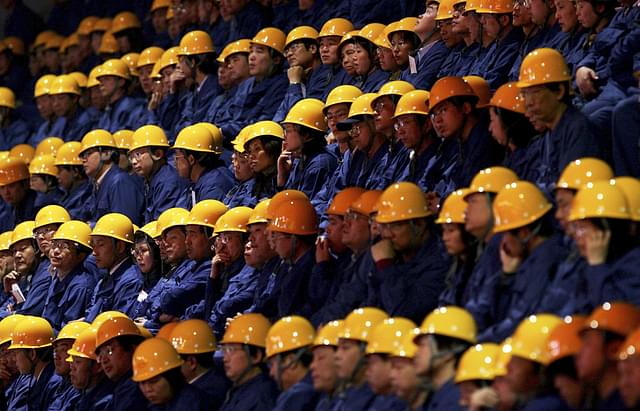 Workers at a factory in China. (Guang Niu via Getty Images)