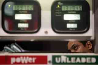 A car owner takes a close look at the metre at a petrol pump. (Manoj Patil/Hindustan Times via Getty Images)