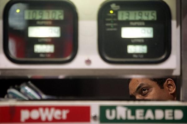 A car owner takes a close look at the metre at a petrol pump. (Manoj Patil/Hindustan Times via Getty Images)
