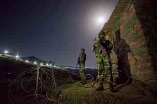 Army soldiers at forward posts beyond the illuminated fence in Hamirpur area near Bhimber Gali. (Gurinder Osan/Hindustan Times via GettyImages)
