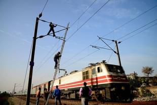 Indian Railways workers repair high voltage train power lines in Jalandhar (Photo credits should read SHAMMI MEHRA/AFP/Getty Images)