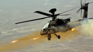 AH-64 Apache Helicopter firing at targets on land. (YouTube)