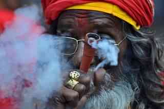 An Indian sadhu puffs cannabis (BIJU BORO/AFP/Getty Images)
