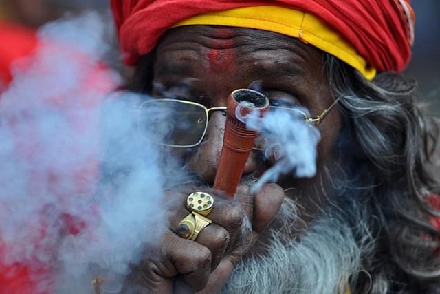 An Indian sadhu puffs cannabis (BIJU BORO/AFP/Getty Images)