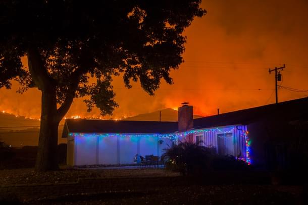 Christmas decorations illuminate a house as the growing Thomas Fire advances toward Santa Barbara County seaside communities in Carpinteria, California. (David McNew/Getty Images) 