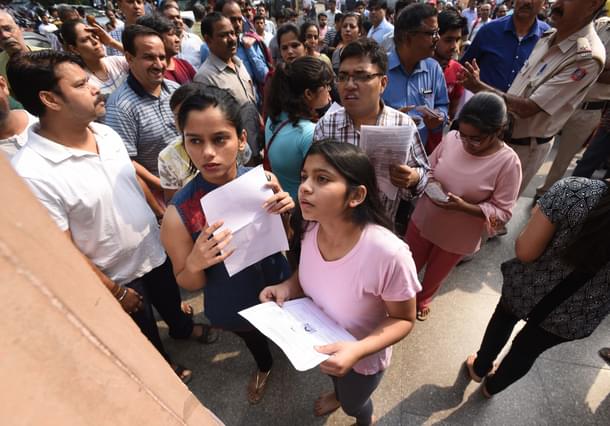 Students check NEET medical entrance exam list at a school in New Delhi. (Raj K Raj/Hindustan Times via GettyImages)