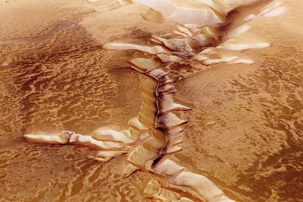 In this handout image supplied by the European Space Agency (ESA), Echus Chasma, one of the largest water source regions on Mars, is pictured from ESA’s Mars Express. The dark material shows a network of light-coloured, incised valleys that look similar to drainage networks known on Earth. (ESA via GettyImages)
