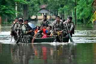 Indian Army soldiers evacuate villagers in the flood affected Jakhalabandha area in Assam. (BIJU BORO/AFP/GettyImages)&nbsp;