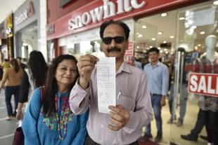 People showing new GST bill outside a store at Connaught place on July 1, 2017 in New Delhi (Ravi Choudhary/Hindustan Times via Getty Images)