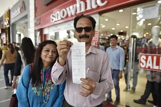 People showing new  GST bill outside a store at Connaught place on July 1, 2017 in New Delhi (Ravi Choudhary/Hindustan Times via Getty Images)