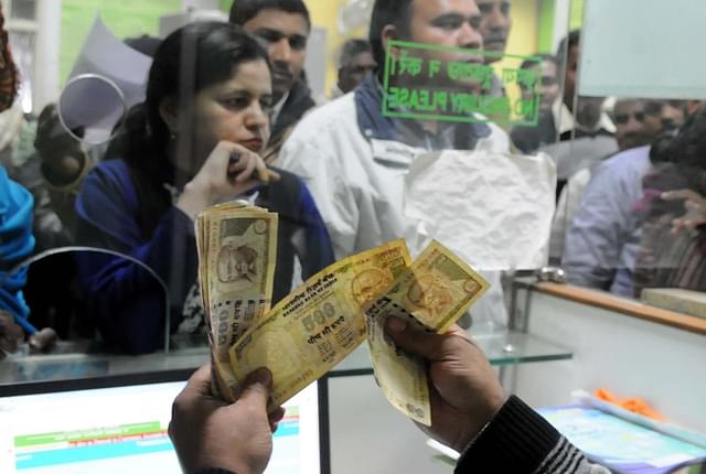 A banker counting old banknotes during demonetisation (Parveen Kumar/Hindustan Times via Getty Images)