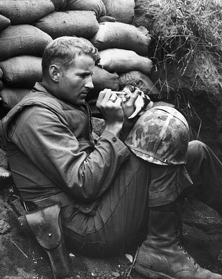 One of the most iconic images from the Korean war where a US Marine feeds an orphan kitten found after a heavy mortar barrage near ‘Bunker Hill’ . (Photo by Sgt Martin Riley/Getty Images)