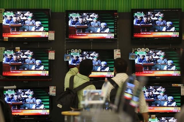 Annual Budget 2011-12 is seen on a TV Screen at the shop at Prabhadevi on Monday.(Kunal Patil/Hindustan Times via Getty Images)