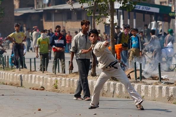 Kashmiri men throw rocks at Indian military. Picture for representation