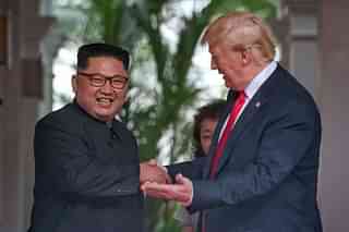 Kim Jong-un (L) with Donald Trump. (Kevin Lim/THE STRAITS TIMES/Handout via Getty Images)