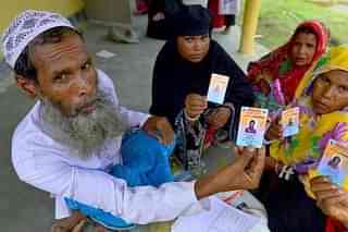 People show their ID cards in Assam. (via Twitter)