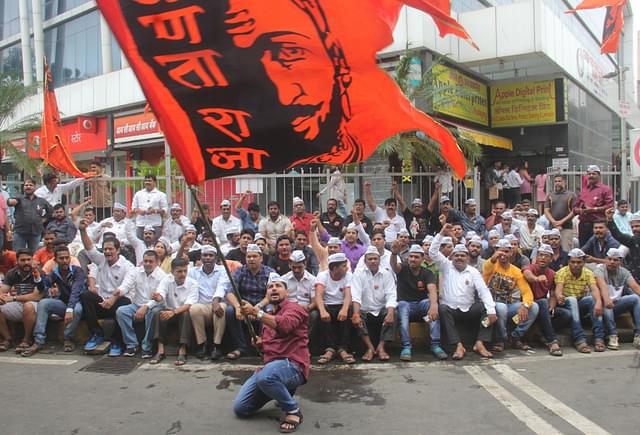 Maratha protestors carry a flag of Chhatrapati Shivaji in Lalbaug, Mumbai (Bhushan Koyande/Hindustan Times)