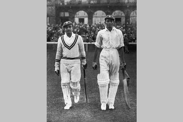 Vijay Merchant (left) and Mushtaq Ali of All India walk out during the first day of play against England in the Test Match at Old Trafford, 25 July 1936. (Keystone/Hulton Archive/Getty Images)