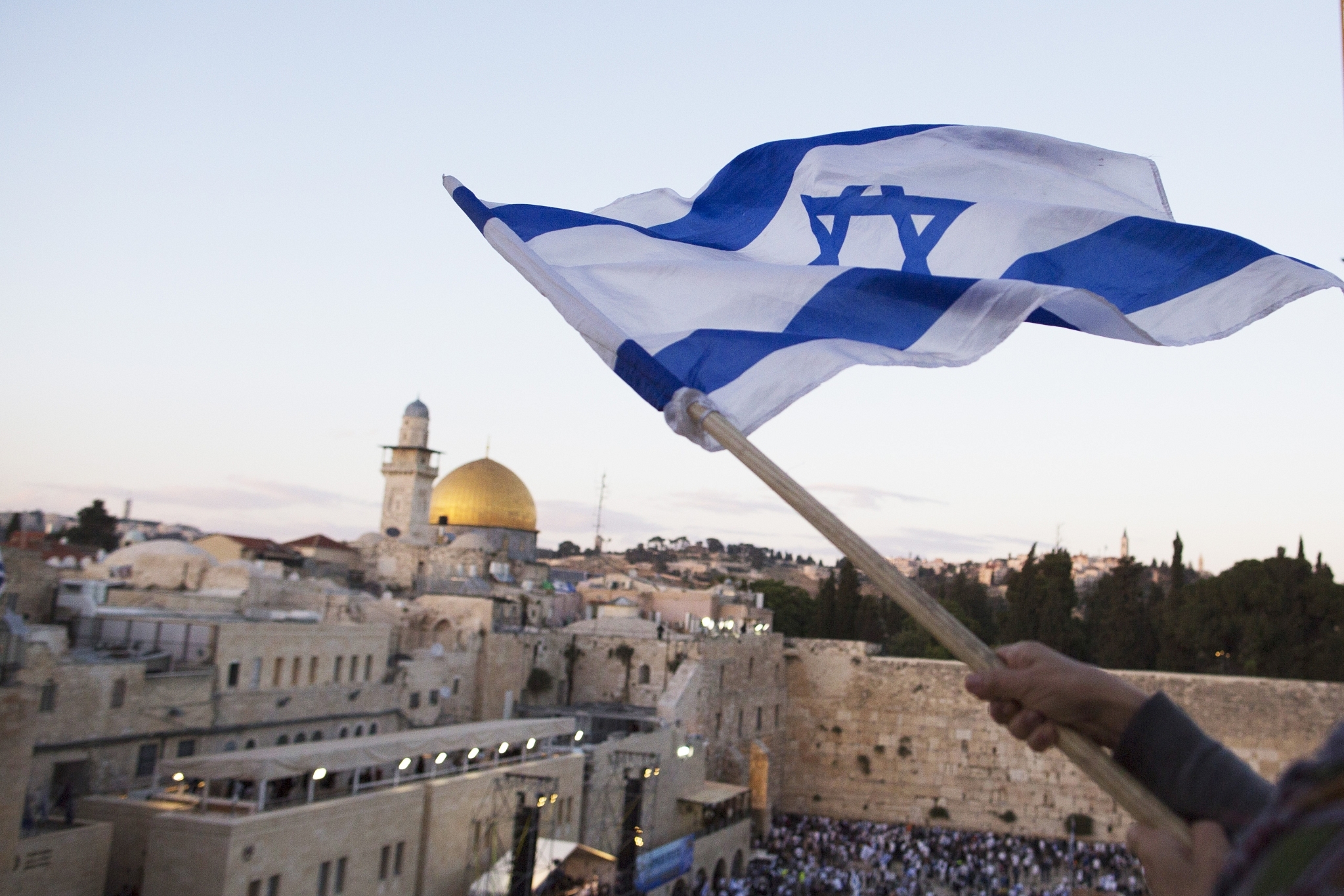 Israelis wave their national flags during a march next to the Western Wall in Jerusalem. (Lior Mizrahi/Getty Images)