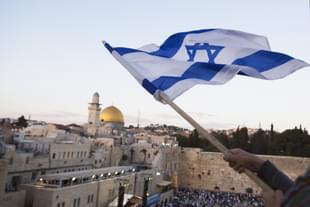 Israelis wave their national flags during a march next to the Western Wall in Jerusalem. (Lior Mizrahi/Getty Images)