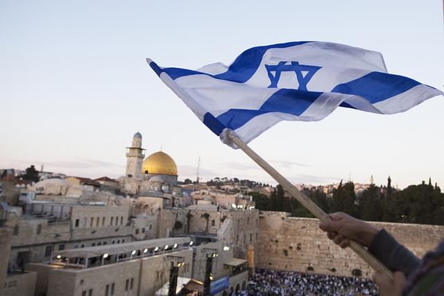 Israelis wave their national flags during a march next to the Western Wall in Jerusalem. (Lior Mizrahi/Getty Images)