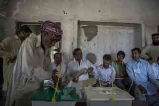 A man casts his vote in Lahore (Daniel Berehulak/Getty Images)