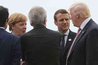 German Chancellor Angela Merkel (L) and French President Emmanuel Macron (2ndR) listen to US President Donald Trump. (MANDEL NGAN/AFP/Getty Images)