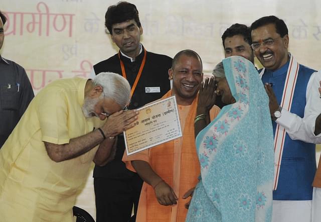 Prime Minister Narendra Modi distributing certificate of Prime Minister Awas Yojana - Gramin in Lucknow, India. (Deepak Gupta/Hindustan Times via Getty Images)