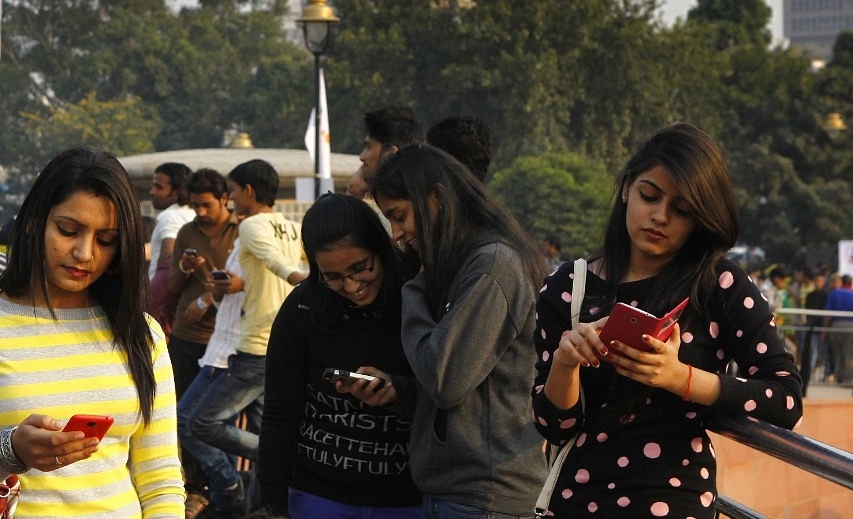 People use free WiFi provided by Tata Docomo at Connaught Place in Delhi in 2014 (Arvind Yadav/Hindustan Times via Getty Images