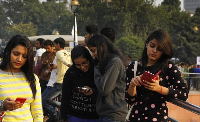 People use free WiFi provided by Tata Docomo at Connaught Place in Delhi in 2014 (Arvind Yadav/Hindustan Times via Getty Images