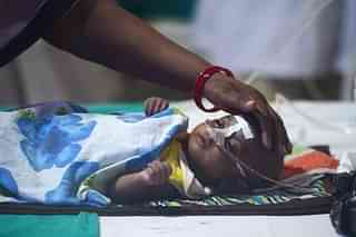 A woman looks after her child at the encephalitis ward of BRD Hospital in Gorakhpur&nbsp;