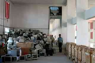 Workers dismantle old computers and electronics. (Uriel Sinai/Getty Images)