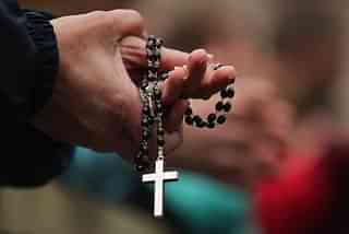 Woman holding a Christian cross. A Representative Image (Dan Kitwood/Getty Images)