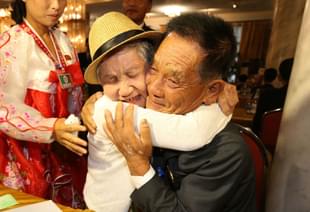 The reunion. (O Jong-Chan-Korea Pool/Getty Images) 