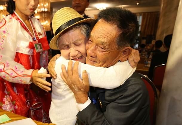 The reunion. (O Jong-Chan-Korea Pool/Getty Images) 