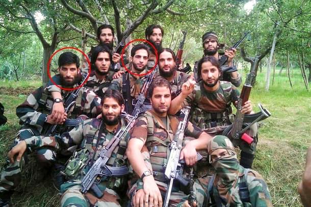 Photograph showing local terrorists donning army fatigues and holding firearms.