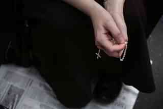 Nun holding a christian cross (Alex Wong/Getty Images)
