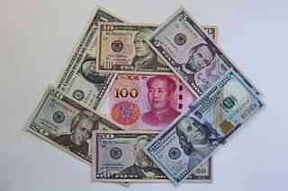 US Dollars and Chinese Yuan (Ulrich Baumgarten via Getty Images)