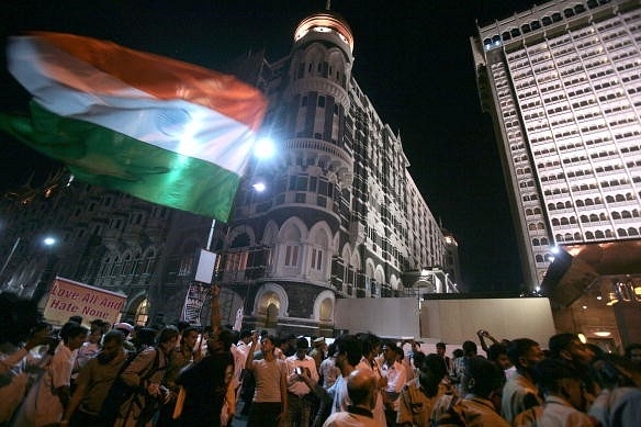  People gather at Taj Mahal Hotel to pay tributes to the victims and martyrs of 26/11 terror attacks, on the first anniversary of the attacks, in Mumbai (Nagesh Ohal/India Today Group/Getty Images)