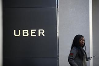 A private security guard stands in front of Uber headquarters  in San Francisco, California (Photo by Justin Sullivan/Getty Images)