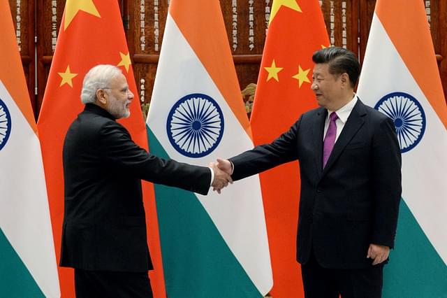 Prime Minister Narendra Modi shakes hands with Chinese President Xi Jinping (Wang Zhou - Pool/Getty Images)