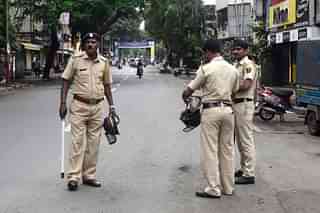 Police officers keep watch in Pune. (Ravindra Joshi/Hindustan Times via GettyImages)