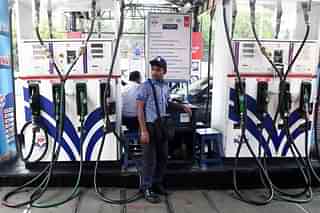 An Indian petrol pump attendant waits for customers at a gas station in Kolkata. (DIBYANGSHU SARKAR/AFP/Getty Images)