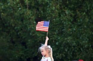 A girl holding the American flag (Mark Makela/Getty Images)