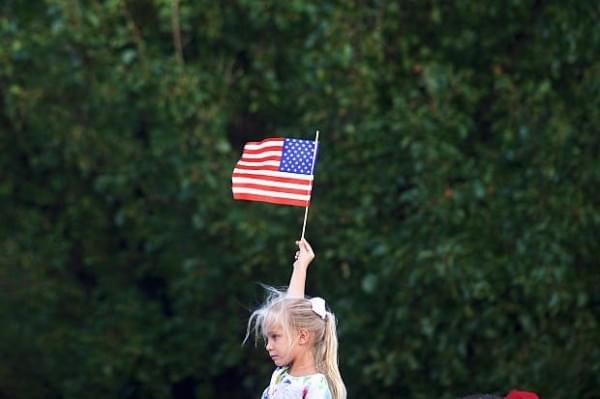 A girl holding the American flag (Mark Makela/Getty Images)